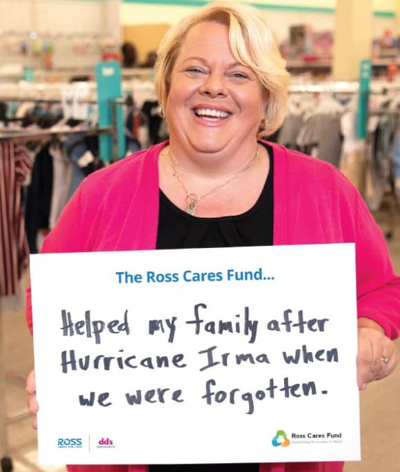 Associate standing in a Ross store and holding a sign that reads The Ross Cares Fund helped my family after Hurricane Irma when we were forgotten.